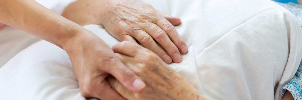 Why It's Difficult to Answer This 'Simple' Question About My Dying Mother Daughter visiting her senior mother in hospital, holding hands