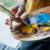Artist holding palette.