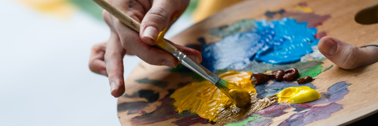 Artist holding palette.