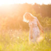 Woman in a meadow at sunset.
