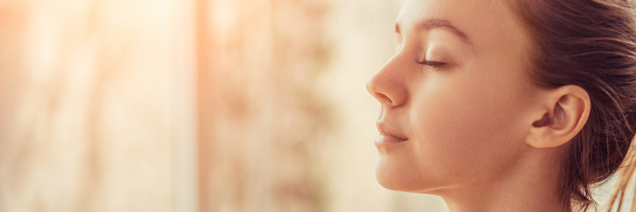 What to Know If Breathing Exercises Only Help Anxiety a Little a woman closing her eyes, she looks peaceful