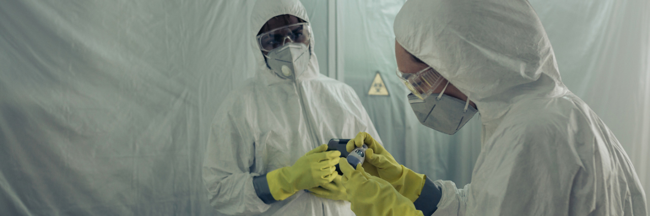 Our Frontline Health Heroes Need Mental Health Support Two healthcare workers in PPE attending to a woman on a stretcher