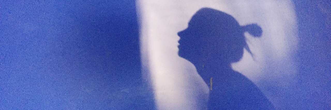 Conflicting Feelings After a Rapists Dies Silhouette of a woman with her hair up