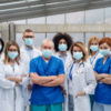 A group of doctors with face masks looking at camera