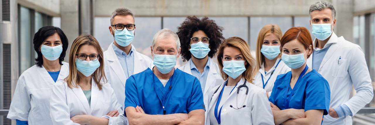 Hospital Workers Aren't Being Told If They're Exposed to COVID-19 A group of doctors with face masks looking at camera