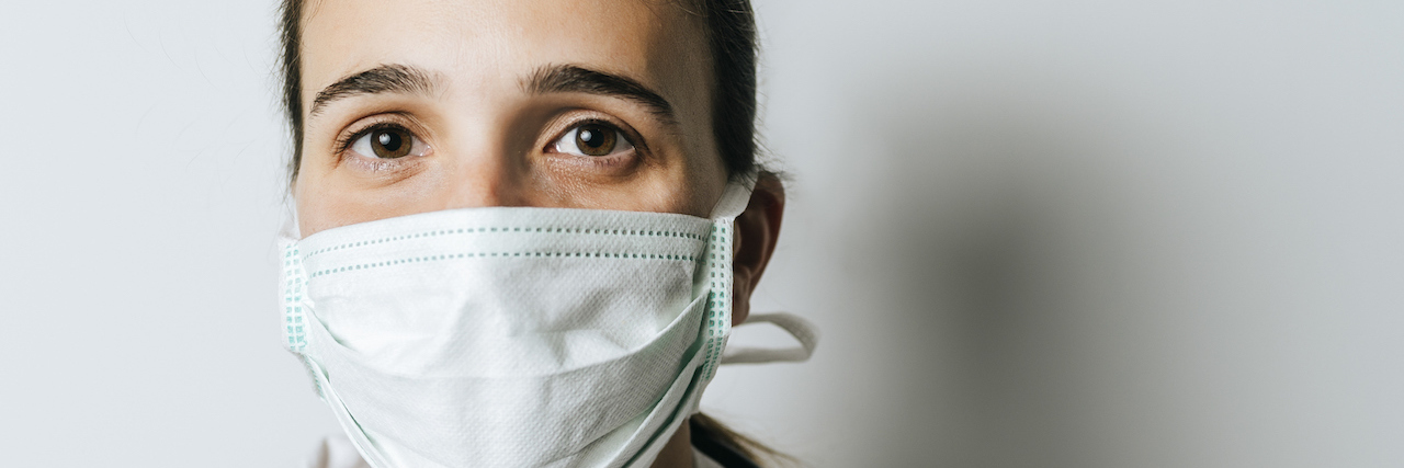 I'm a Symptomatic Nurse Who Was Refused COVID-19 Testing A nurse with a mask on her face