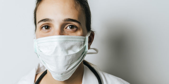 A nurse with a mask on her face