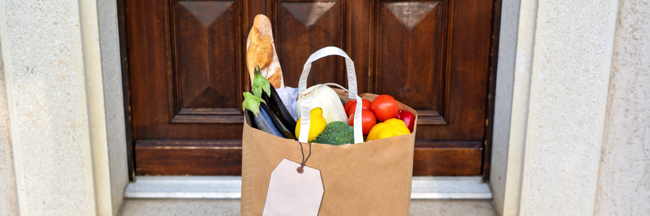 Helping a Loved One With Chronic Illness During COVID-19 Lockdown Paper bag with groceries outside door.