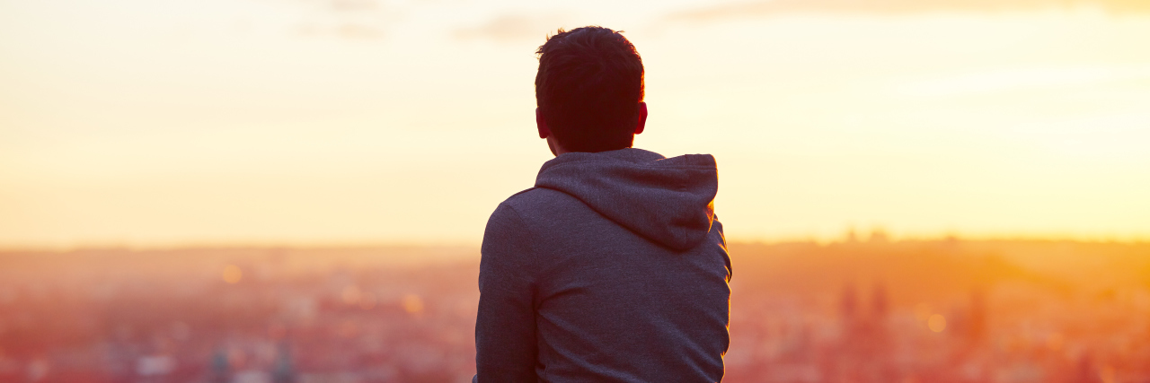 18 Ways to Prepare for (and Cope with) Difficult Days of Treatment-Res Young man is looking at the sunrise