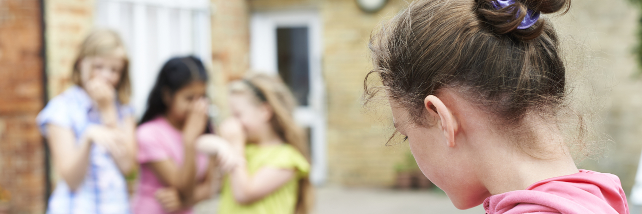 The Process of Accepting My Learning Disability three girls are snickering at another little girl outside school