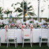 table outside, decorated in white and pink for a wedding