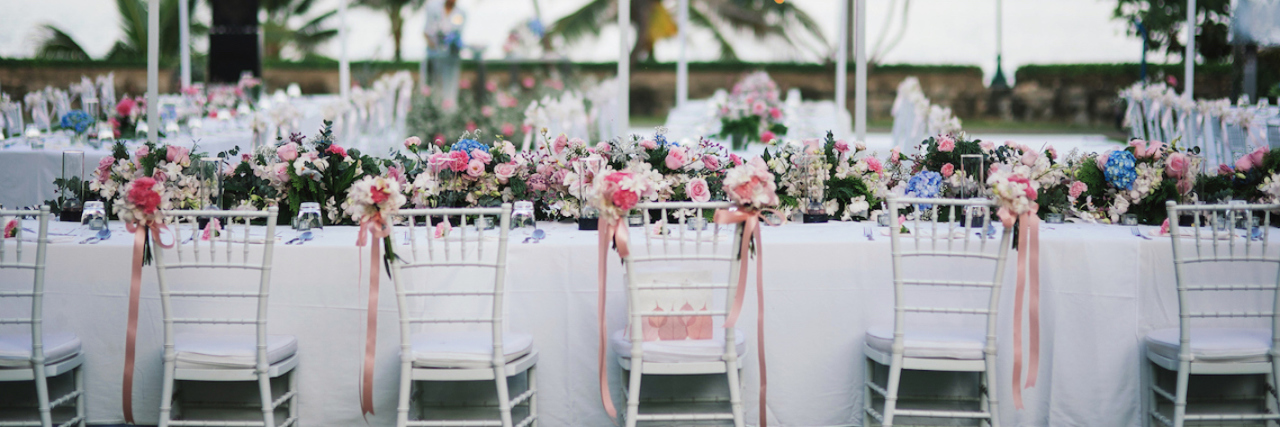 table outside, decorated in white and pink for a wedding