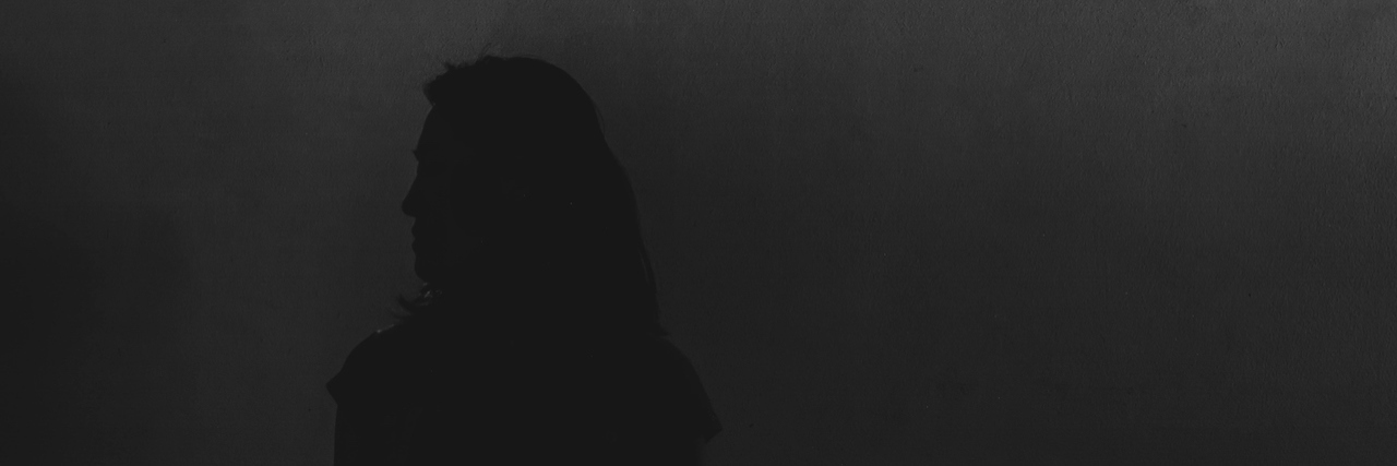 silhouette of woman in the dark