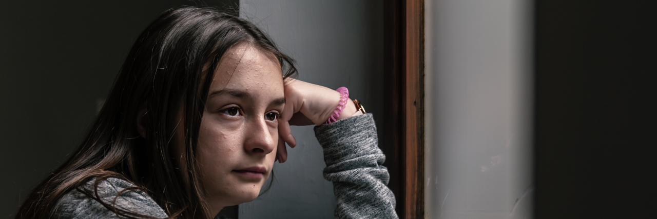 What It's Like Being a Teenager With Chronic Pain Sad and contemplative teenage girl.