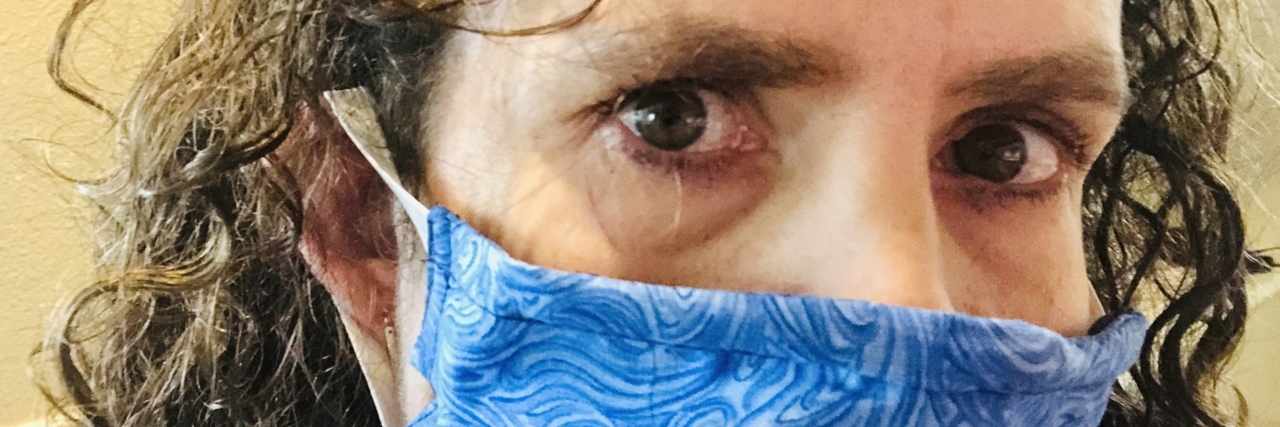 Why Wearing a Mask During COVID-19 Is Essential Christie wearing a blue mask.