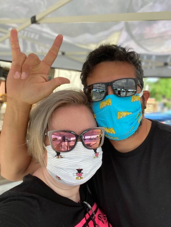 Woman and her husband wearing colorful face masks and sunglasses