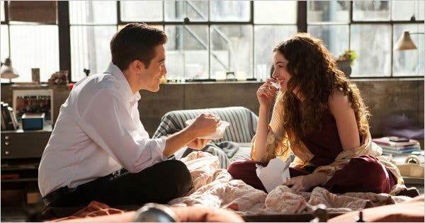 The two lead characters of Love and Other Drugs eat a meal in bed