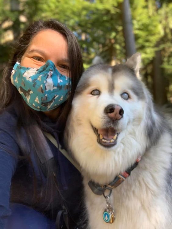 Woman wearing face mask with a dog