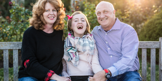 How We're Holding On To Hope for Our Child With a Rare Disease the parents of Elouise and Elouise, sitting and smiling