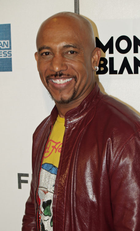 Montel Williams in a red leather jacket on the red carpet