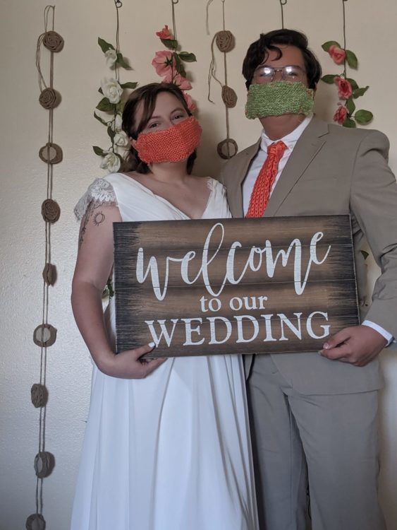 married couple wearing face masks on wedding day