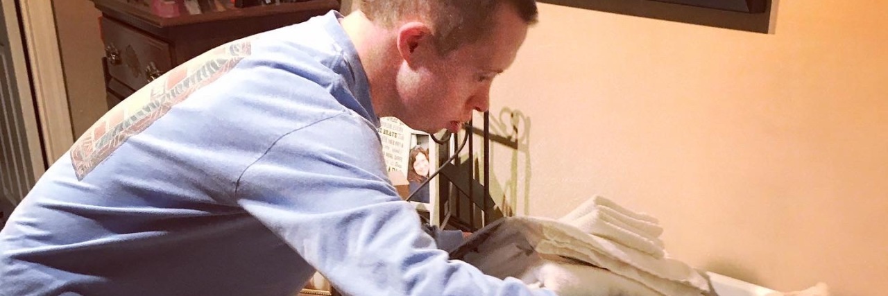 Supporting a Person With Down Syndrome and Autism During COVID-19 Nick doing laundry.