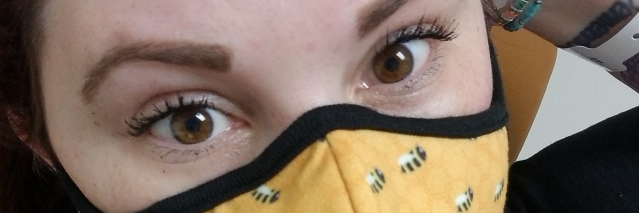 Chronic Illness Doesn't Go Away During the COVID-19 Pandemic Sarah wearing a yellow cloth mask.