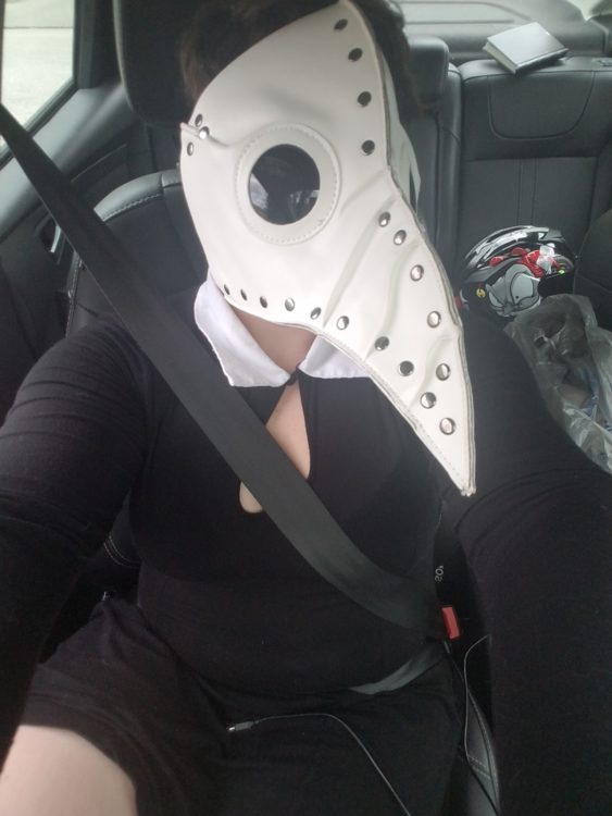 woman wearing a bird mask