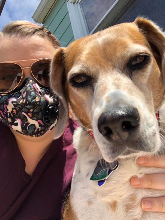 selfie of woman wearing mask with dog