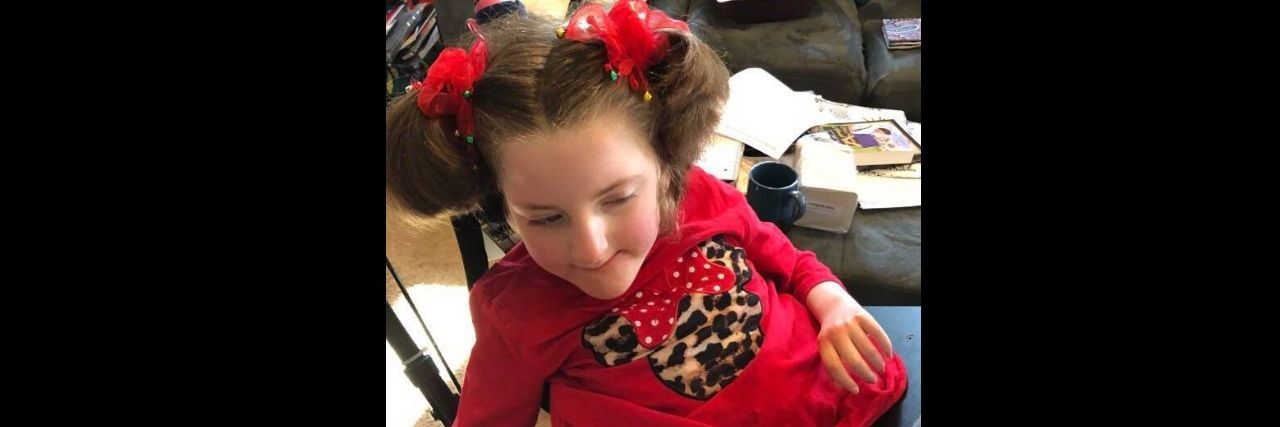 Lessons From COVID-19 About Teaching My Daughter With a Disability a little girl sitting in her living room