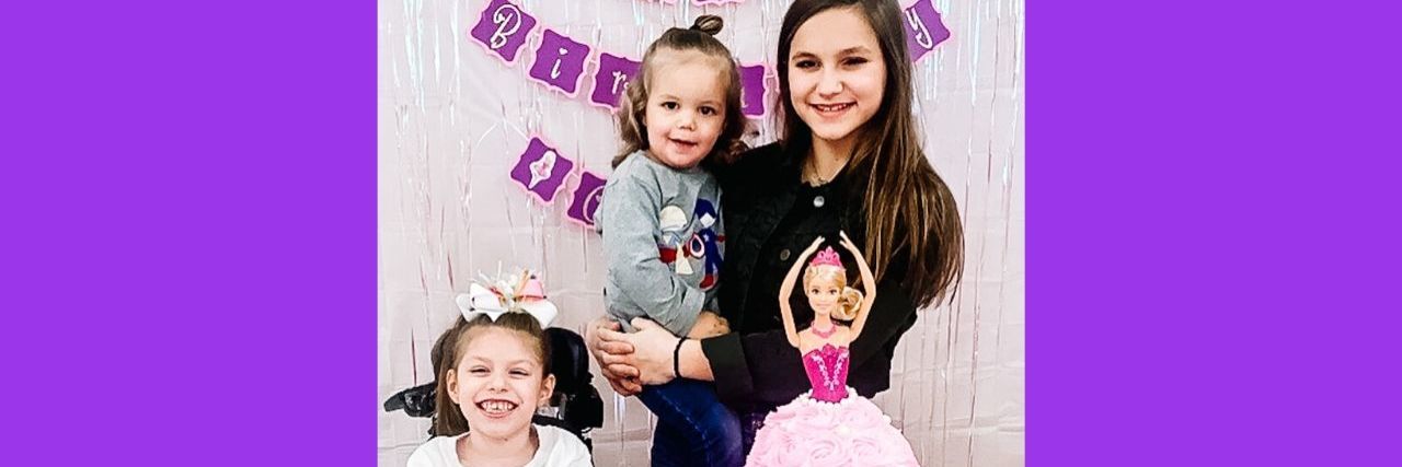 5 Tips for Co-Parenting a Child With a Disability Three young sisters are sitting near a birthday cake.