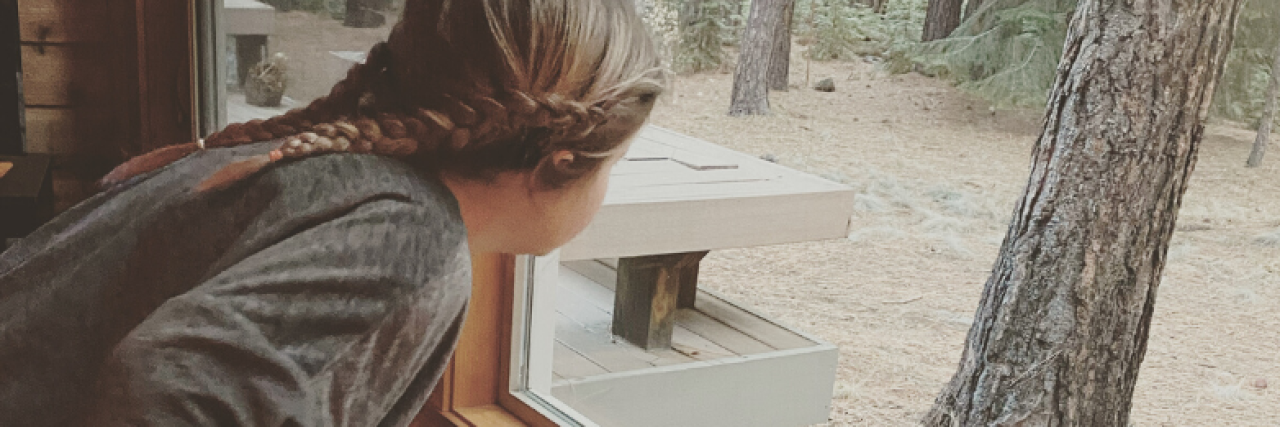 A Letter to My 10-Year-Old Daughter About Her Anxiety The author's daughter and her dog looking out a window