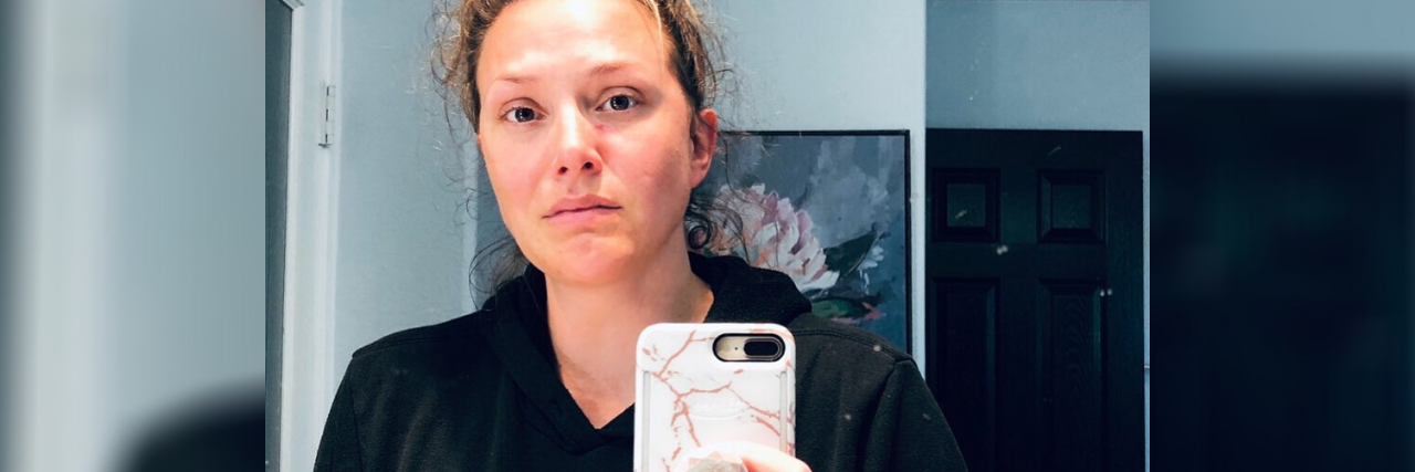 A Letter to Parents Who Need Support During COVID-19 The author, looking serious with messy hair, taking a mirror selfie