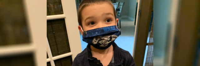 Amy's son on the autism spectrum wearing his Star Wars face mask.