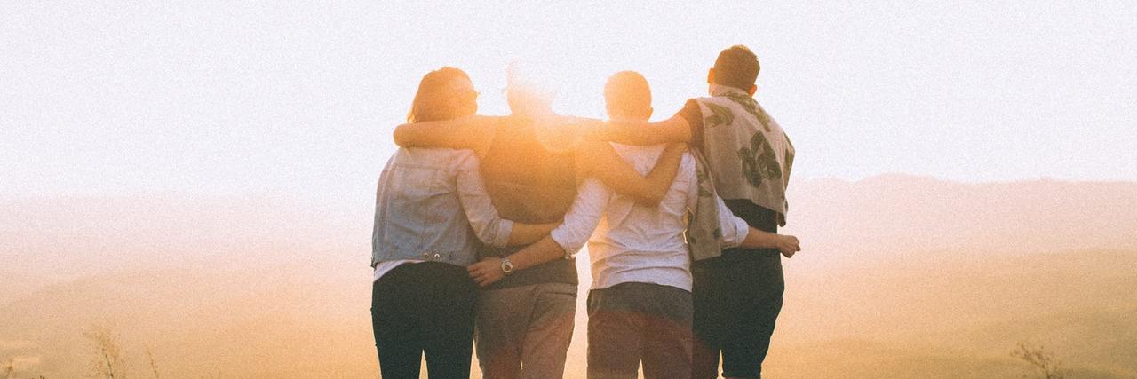 The Importance of Connecting With Others Who Live With Chronic Illness Friends with linked arms at sunrise.