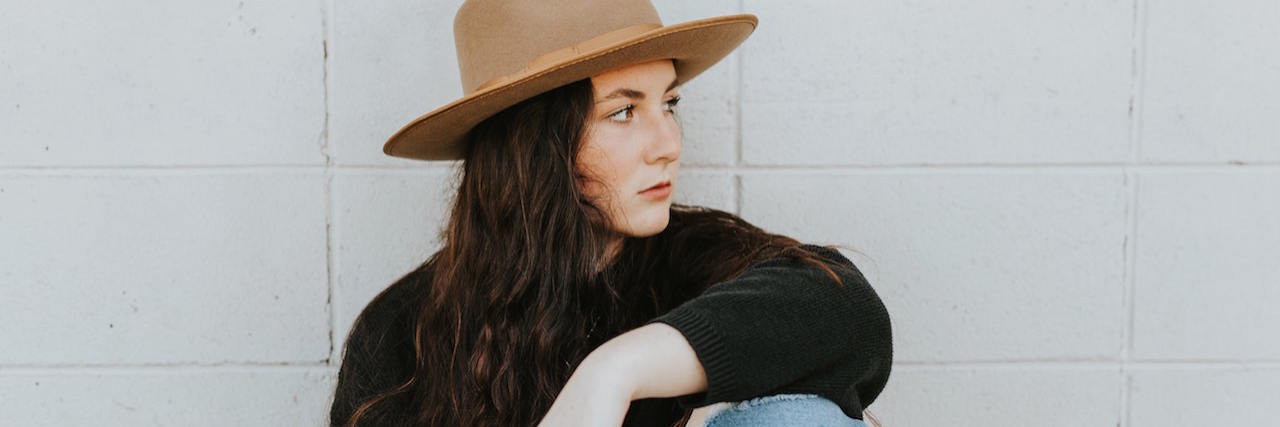 20 'Truths' That Helped Me Recover From Mental Illness A woman in a sat, sitting and looking to the side