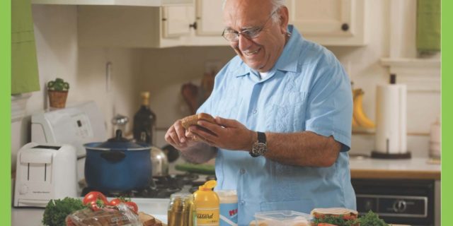 How California Is Now Helping People With Disabilities Stay Safer From COVID-19 Flyer advertising that CalFresh Food benefits can now be used to purchase groceries online at select retailers. Photo of a man in his kitchen holding bread and a knife, making a sandwich.