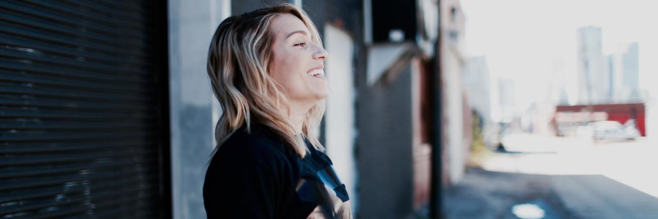 I'm Worried Showing My Friends My Depression Will Make It More Real photo of blonde woman with closed eyes smiling