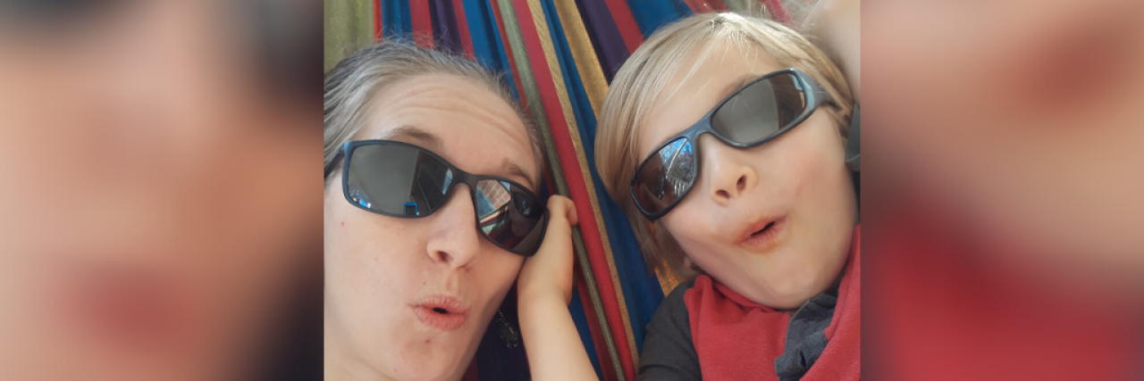 What It's Like Living in Isolation With Chronic Illness Contributor and her son wearing sun glasses