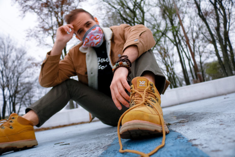 man wearing a face mask made in kiss fabric