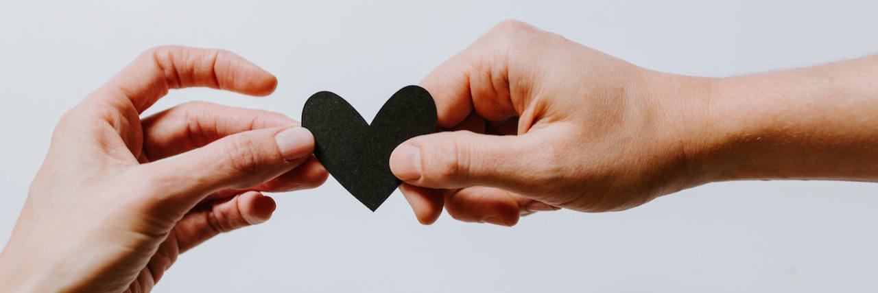 A Letter to the People Who Helped My Mental Health A hand holding onto a black heart