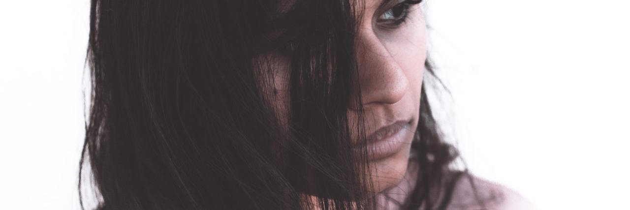 Letter to Psychiatrist Who Sent Me to the ER When I Was Suicidal A woman with dark hair looking away