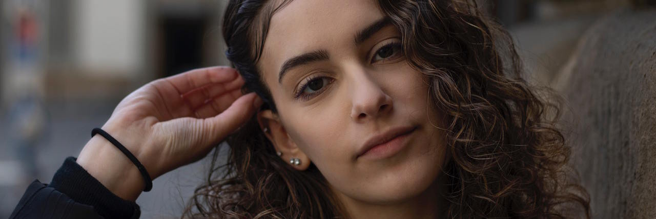 As an Abuse Survivor, I Thought Being Mean Would Protect Me A woman with curly brown hair