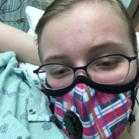 Meghan wearing her mask at the hospital.