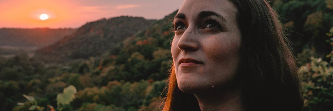 Advice for Managing Fibromyalgia A woman outside, looking up and hopeful