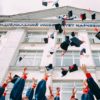 graduates throwing up their caps in the air