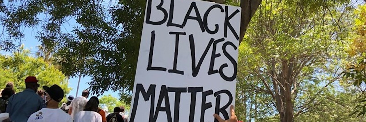 Protester holding a Black Lives Matter sign