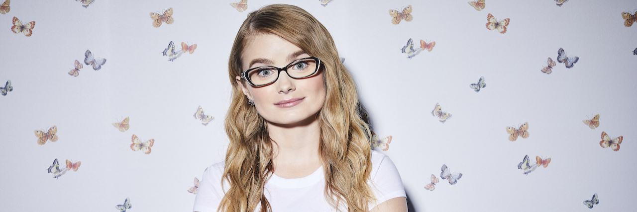 Actress Kayla Cromer Has a Message About Neurodiversity "Everything's Gonna Be Okay" star Kayla Cromer, a white girl with long blonde hair wearing a blue dress and glasses