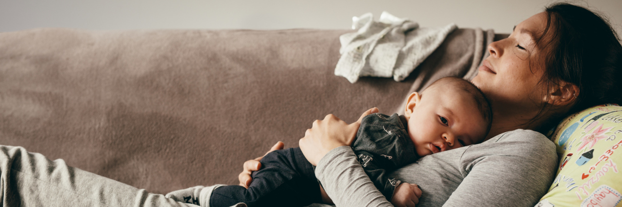 Migraine Awareness Month: What Migraines Have Taught Me Mother sleeping on a couch with her baby.