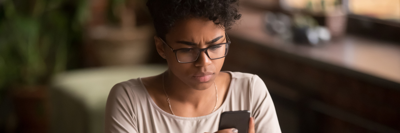 What It's Like to Process Police Brutality With a White Therapist A black woman looking at her phone